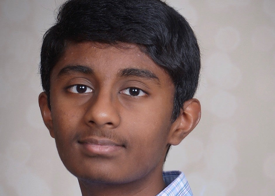 Vishnu Mukku Young man wearing a blue plaid shirt against a plain background
