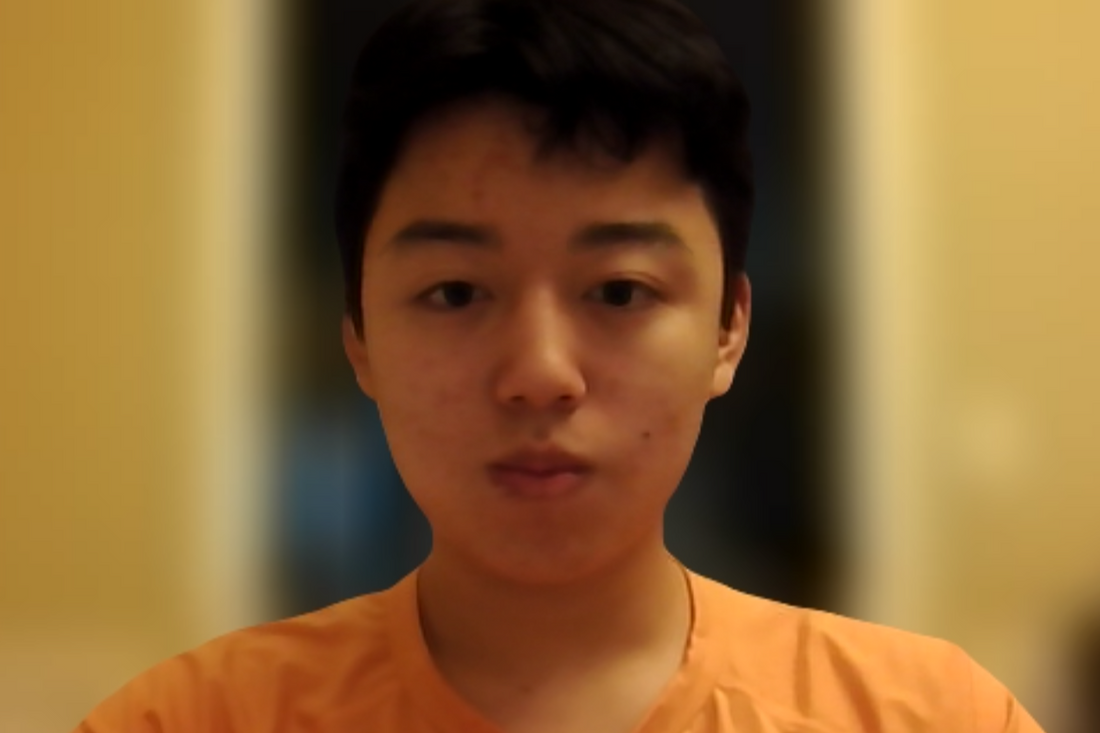 Young man wearing an orange shirt with a blurred background 
