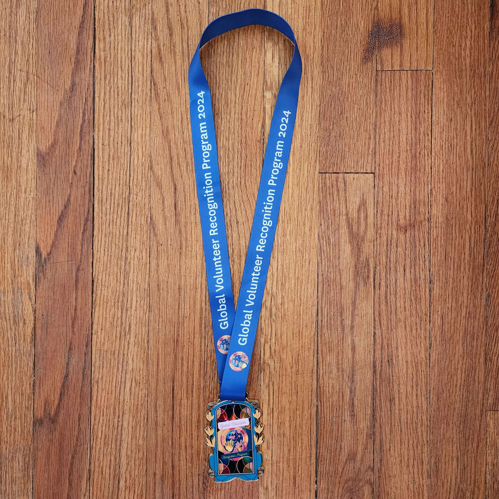2024 Global Volunteer Recognition Program Membership Blue lanyard with a colorful badge holder 