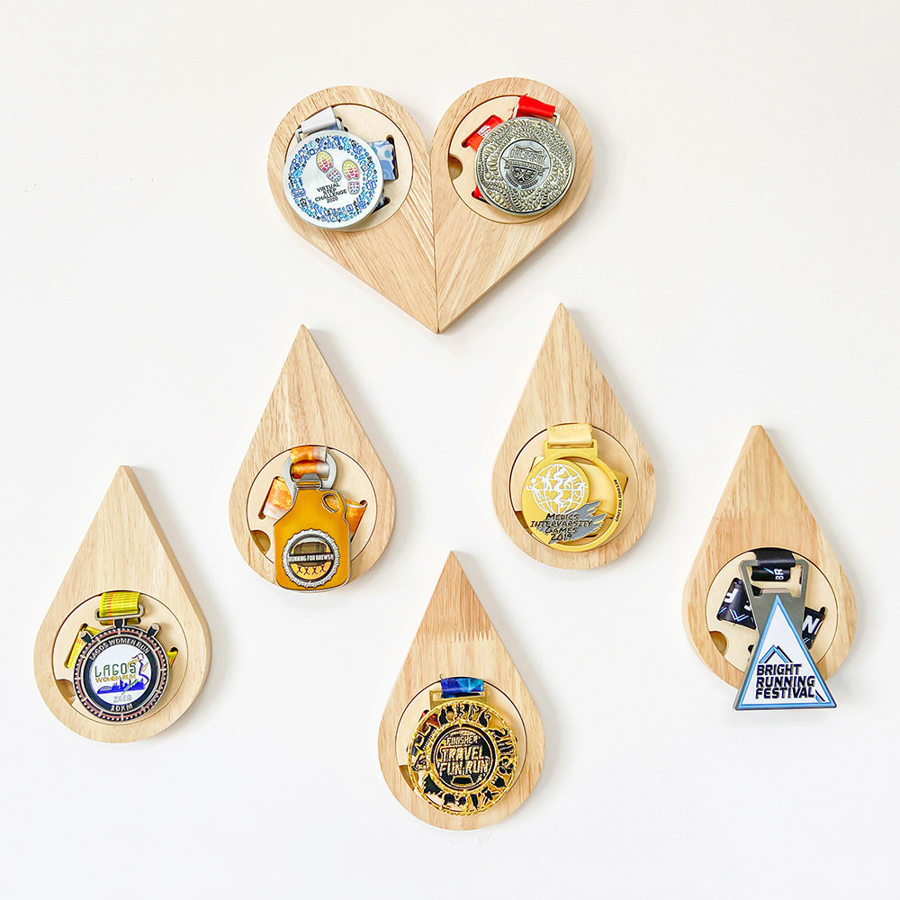 Set of wooden teardrop-shaped bottle openers with various designs on a white background