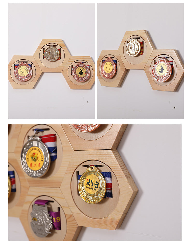 Hexagonal wooden display with various medals on a white background