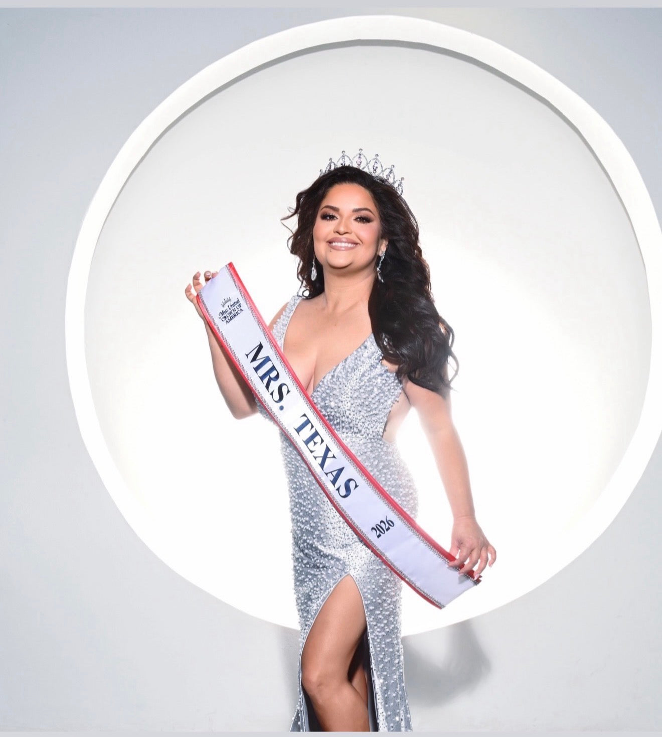 Woman wearing a 'Mrs. Texas' sash against a white background