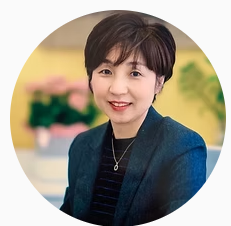 Lady wearing blue jacket and smiling 