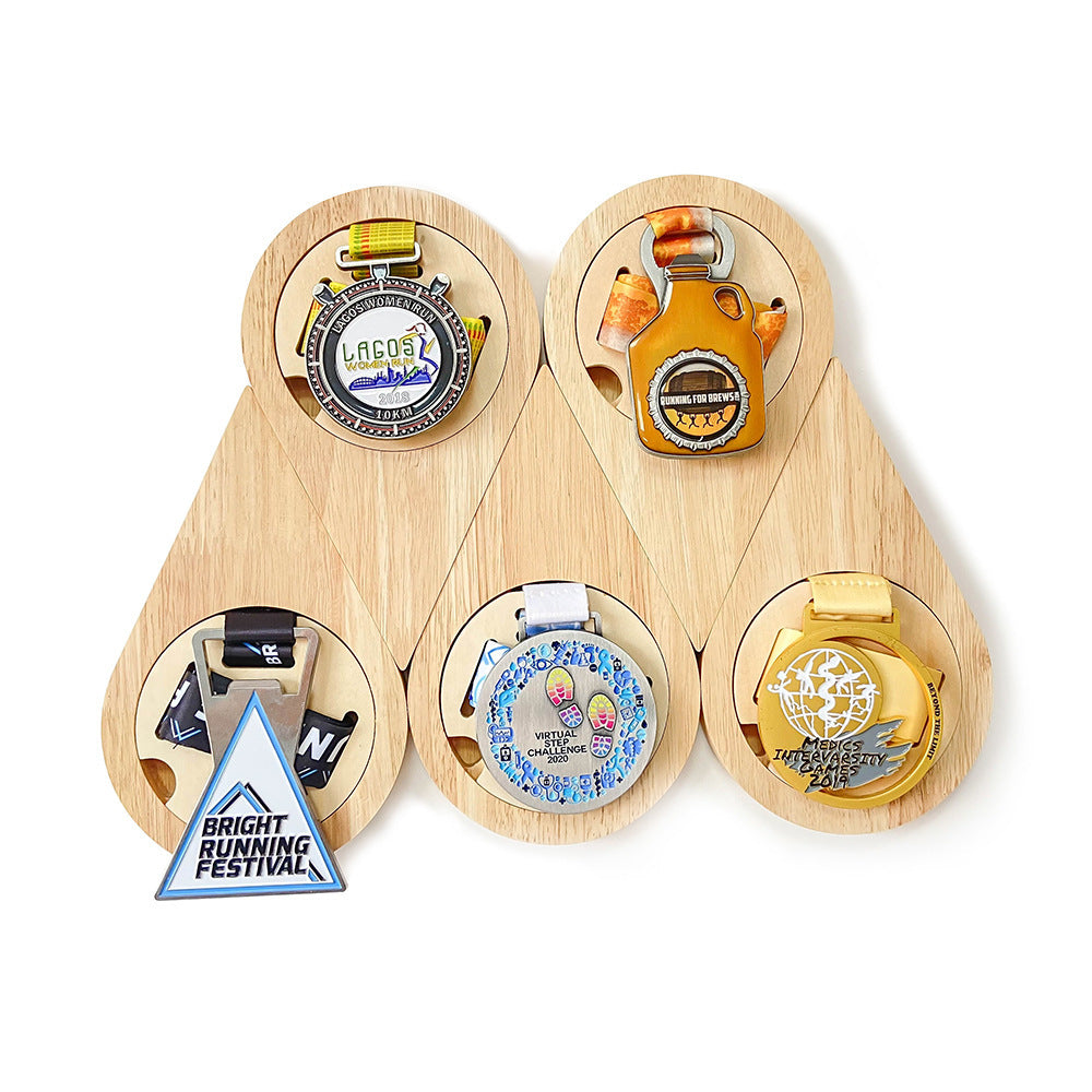 Set of wooden teardrop shaped display with various designs on a white background