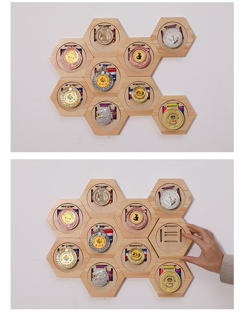 Hexagonal wooden display with various medals on a white background