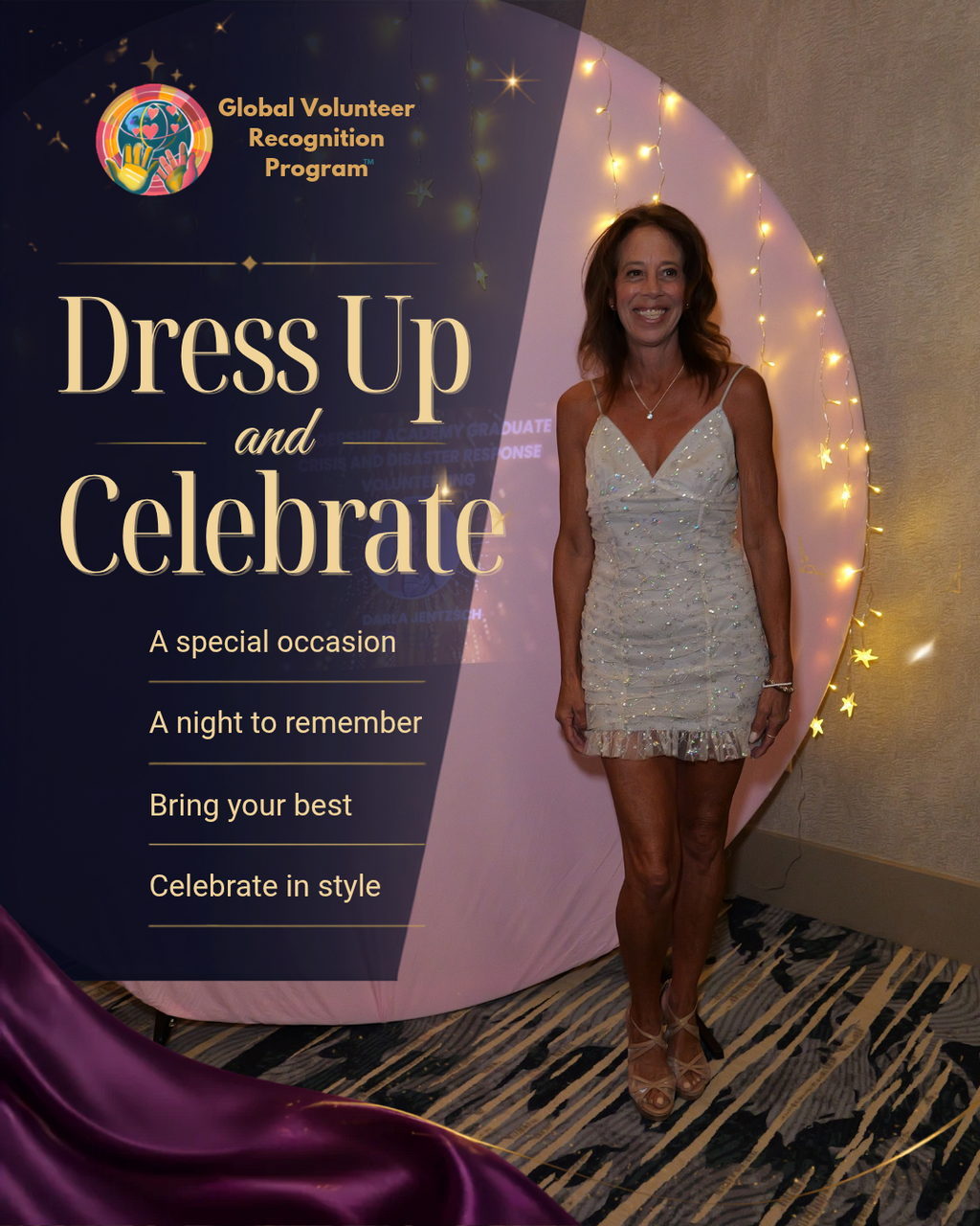 A woman stands in front of a decorative event backdrop that reads 'Global Volunteer Recognition Program' and 'Dress Up and Celebrate,' wearing a short white embellished dress and tan heels.
