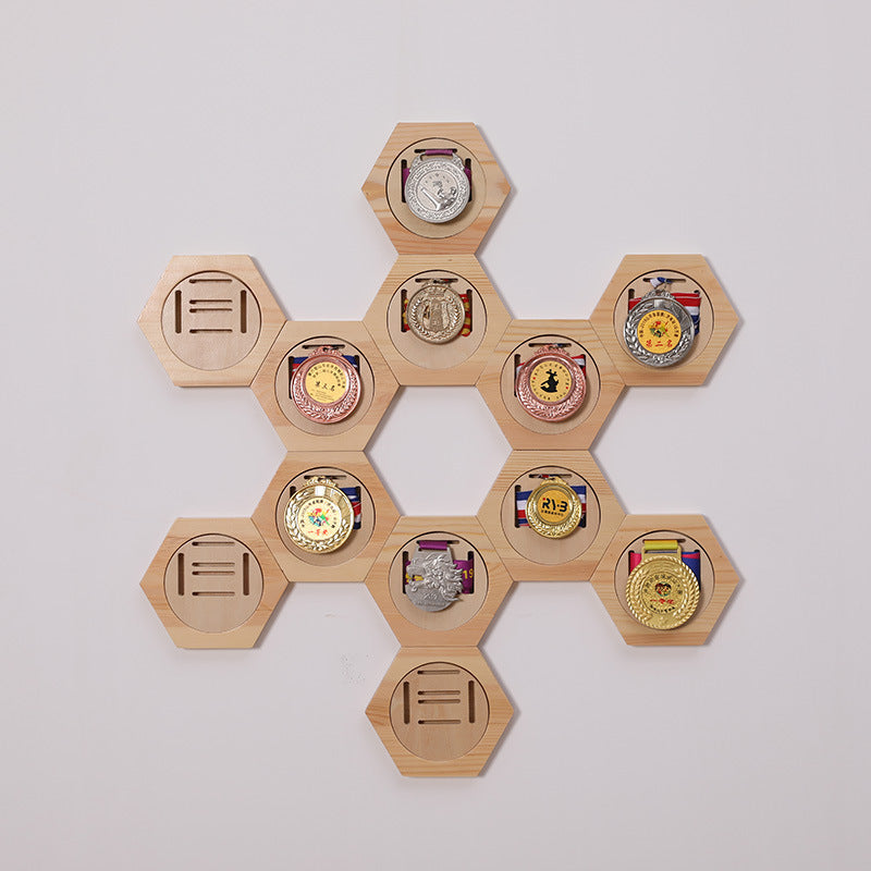 Hexagonal wooden display with various medals on a white background