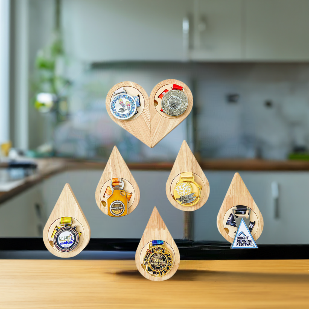 Set of wooden teardrop-shaped bottle openers with various designs on a white background