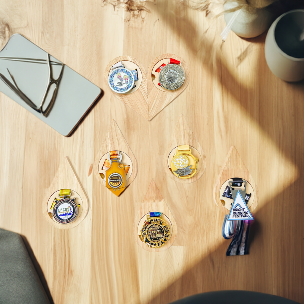 Set of wooden teardrop-shaped bottle openers with various designs on a white background