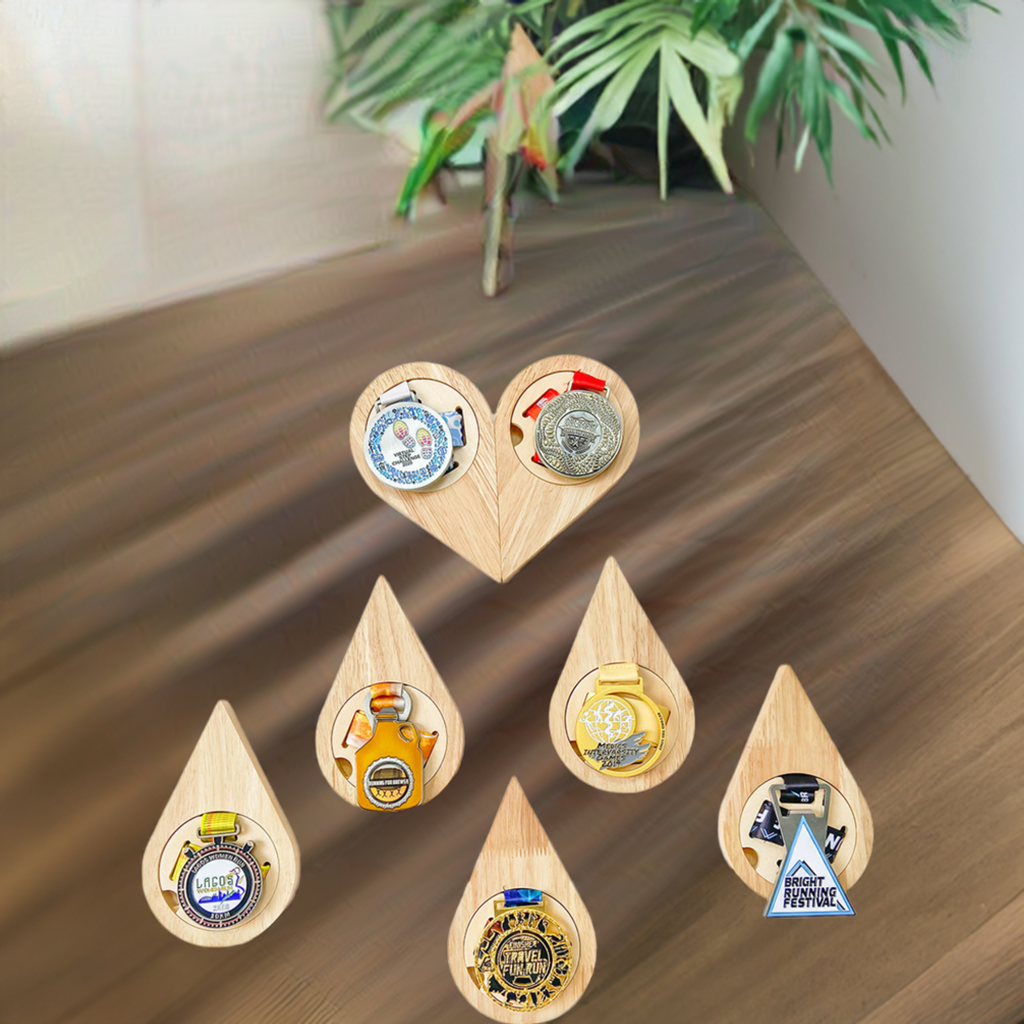 Set of wooden teardrop-shaped bottle openers with various designs on a white background
