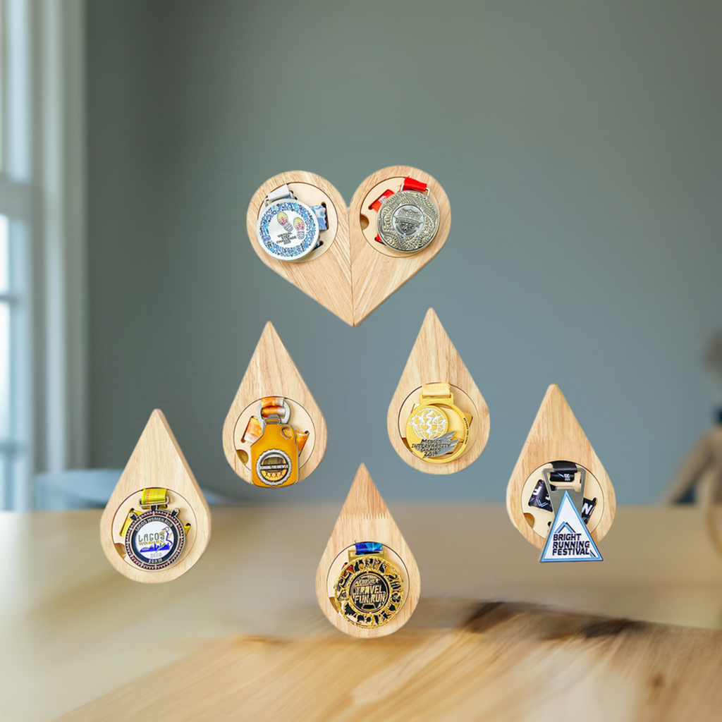 Set of wooden teardrop-shaped bottle openers with various designs on a white background