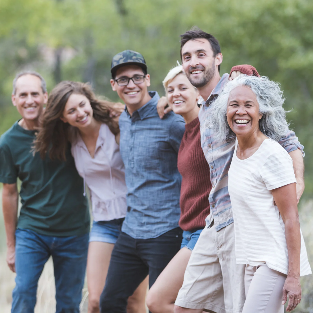 Group of people standing together outdoors with a natural background