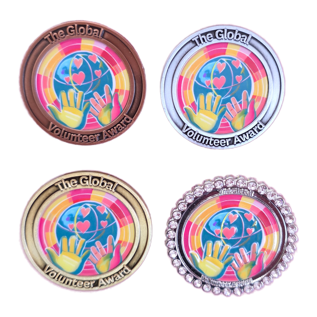 Four 'The Global Volunteer Award' coins with different designs on a white background