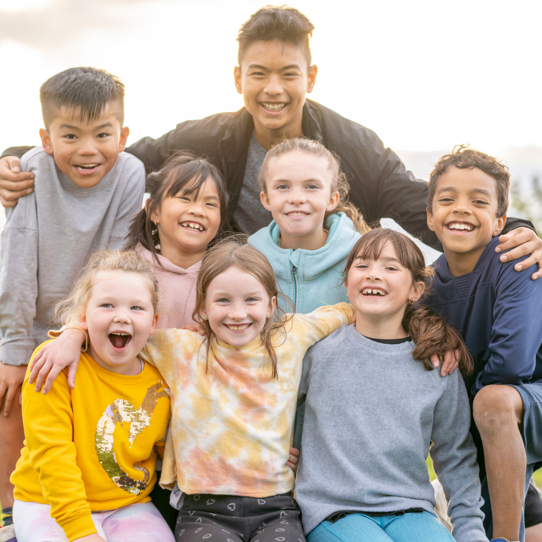 Group of children posing together outdoors